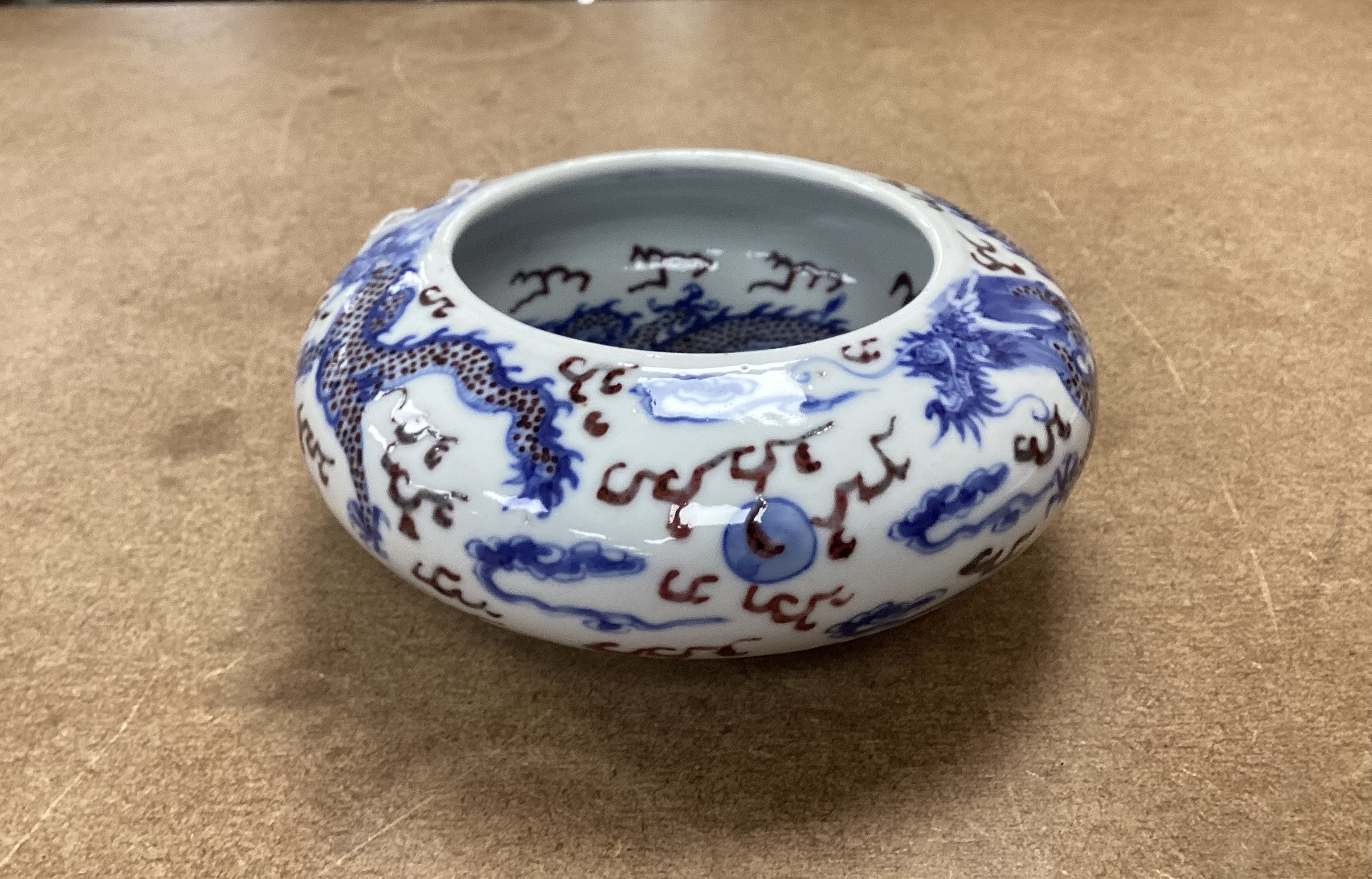 A Chinese underglaze blue and copper red ‘Dragon’ brushwasher, Guangxu period, 15cm diameter